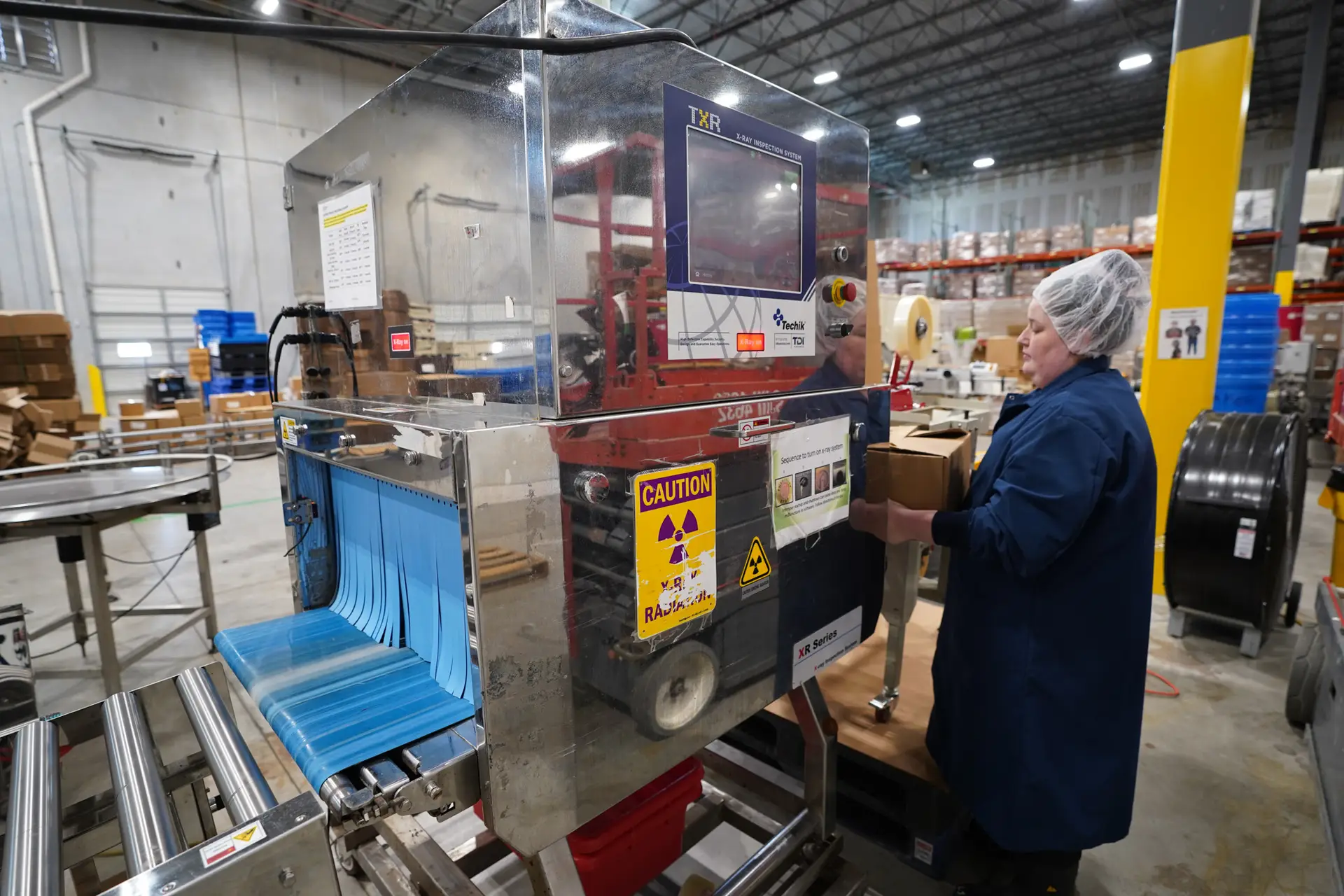 Larissa inspects X-ray equipment on a food production line